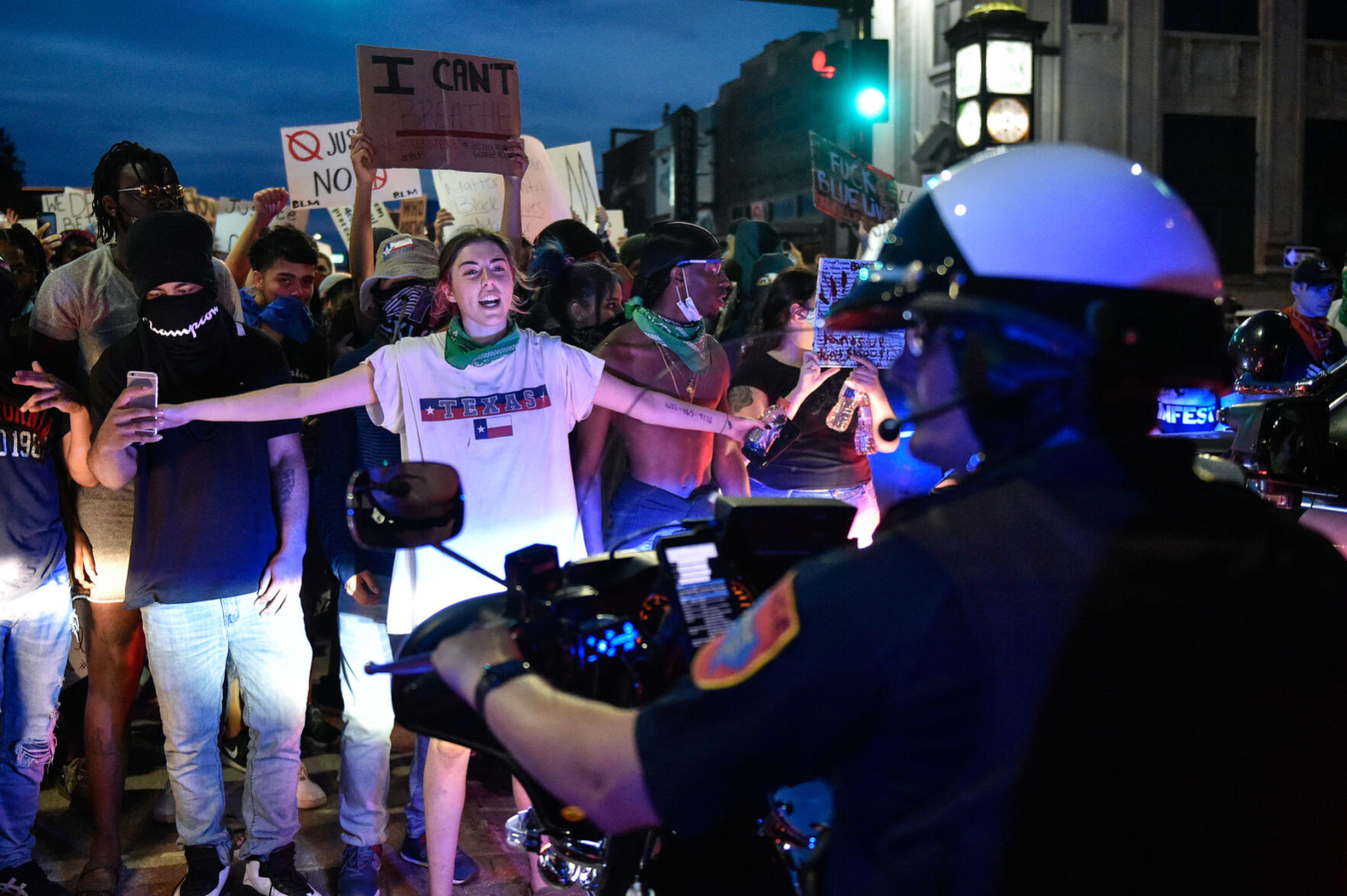 Motorcycle officer and protesters